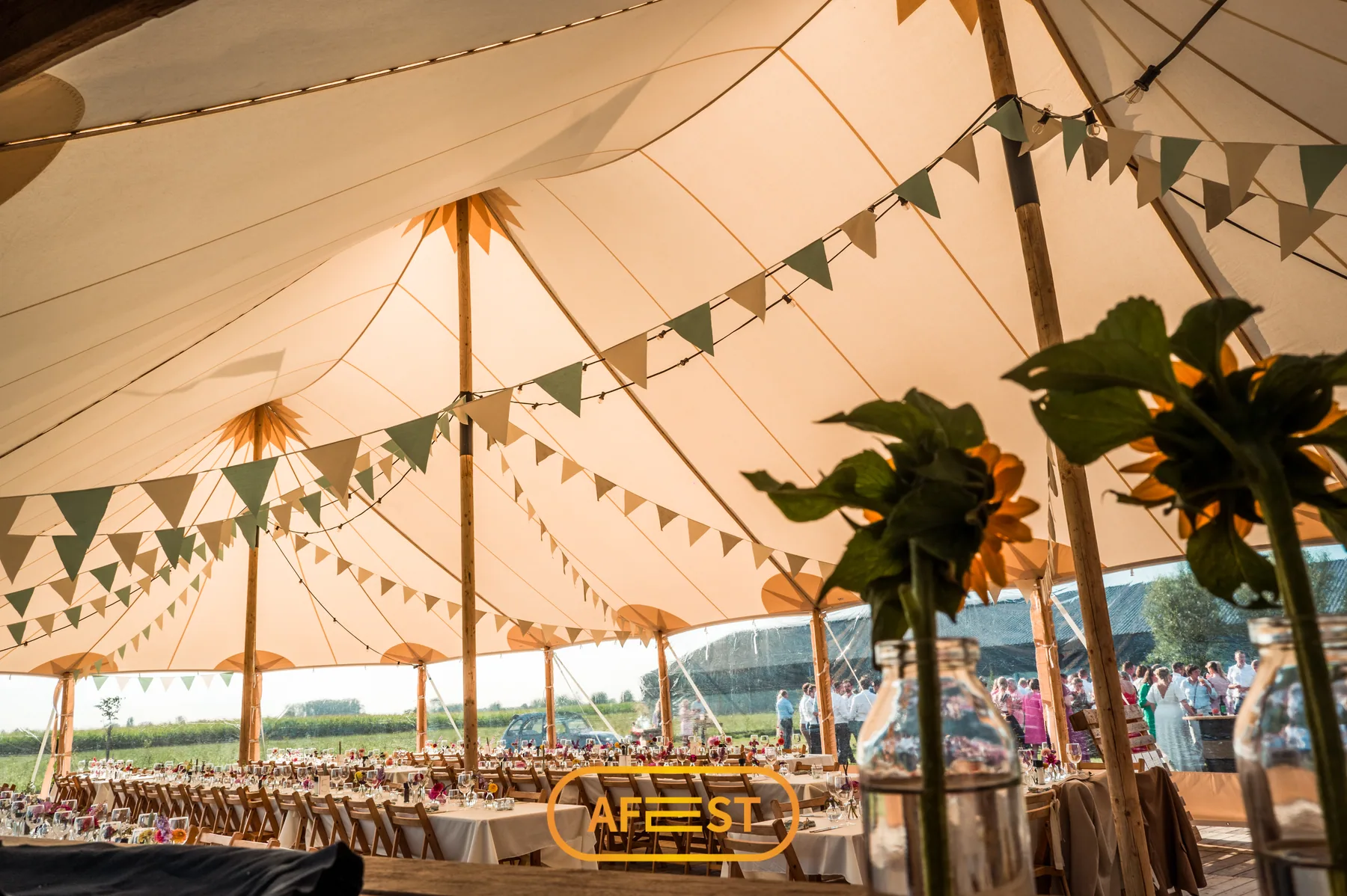 Binnenzicht sailcloth tent met gedekte tafels en vlaggenlijnen